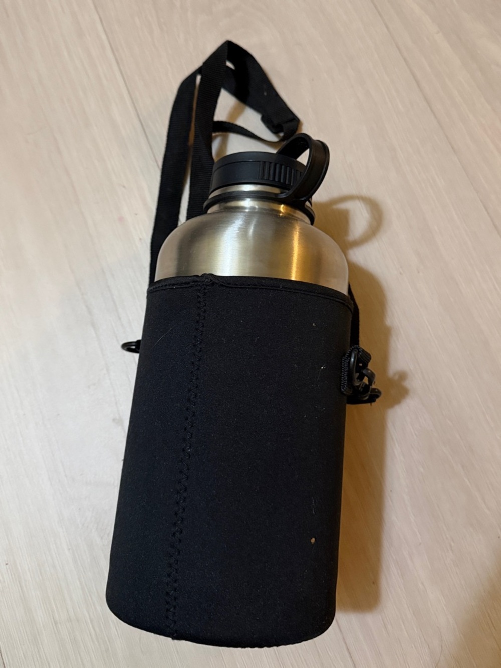 Amazon Silver Stainless Steel Bottle with Black Neoprene Carry Sleeve and Strap